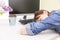 Young pretty woman tired and exhausted of work lying on table in front of computer and taking a break