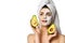 Young pretty woman whalf of face in facial mask and with the other half clean holds cut in half fresh avocado. Beauty skin care