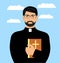 A young priest with the Bible on a background of blue sky with clouds