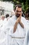 A young priest prays during the Corpus Christ procession