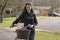 Young priest using a bicycle to visit her parish