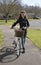 Young priest using a bicycle to visit her parish