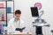 A young primary care physician reviews book calendar entries about his patients. The doctor's office