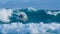 Young pro surfer dude surfing fun ocean waves in the sunny Canary Islands.