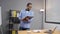 Young professional african businessman worker with tablet standing in office, smiling