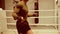 Young professional boxer with athletic body is skipping on jumping rope on ringside.