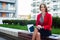 Young professional business woman sitting outdoor with computer