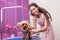 Young professional groomer grooming yorkshire terrier in pet salon