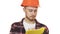 Young professional male architect in a hardhat making notes