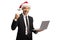 Young professional man in a suit with a Santa Claus hat gesturing happiness and holding a laptop computer