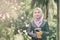 Young professional muslimah businesswoman holding a tablet in the park