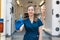 Young professional nurse in medical uniform, show syringe in her hands at ambulance background