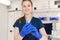 Young professional nurse in medical uniform, show syringe in her hands at ambulance background