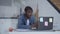Young professional talking at laptop web camera gesturing. Portrait of confident African American concentrated positive