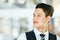 Young professional waiter, bartender or host looking confident, serious and wearing formal uniform on a blurred