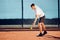 Young proffesional tennis player doing a serve