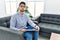 Young psychologist man at consultation office puffing cheeks with funny face