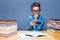 Young pupil playing on his phone in classroom