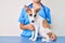 Young puppy at the veterinarian going to health checkup, professional examining dog using stethoscope