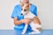 Young puppy at the veterinarian going to health checkup, professional examining dog using stethoscope