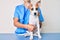 Young puppy at the veterinarian going to health checkup, professional examining dog using stethoscope