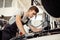 A young but qualified mechanic is conducting a detailed examination of a car
