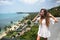 The young quite stylish sensual woman posing on the amazing tropical beach with the blue ocean enjoy her holiday and a windy summe