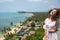 The young quite stylish sensual woman posing on the amazing tropical beach with the blue ocean enjoy her holiday and a windy summe