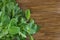 Young radish leaves on a wooden background. Useful leaves for salad. Greens for cooking. Great food. Copy space