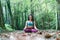 Young rasta woman doing yoga lotus pose in the park Â¡