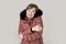 Young read hair attractive and sweet woman 20s or 30s posing isolated wearing warm winter jacket with fur hood shivering and freez