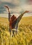 Young red hair woman standing back hands up to breathtaking view