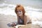young red-haired girl on the beach