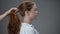 Young red-haired girl combing her hair.