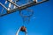 Young red-haired guy throws a ball into a basketball hoop