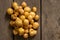 young red-haired small peeled potatoes lie on a wooden table close up