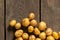 young red-haired small peeled potatoes lie on a wooden table close up