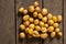 young red-haired small peeled potatoes lie on a wooden table close up