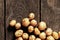 Young red-haired small peeled potatoes lie on a wooden table close up