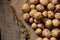 Young red-haired small peeled potatoes lie on a wooden table close up