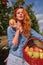 Young red-haired woman helps with picking apples