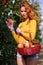 Young red-haired woman helps with picking apples