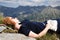 Young red haired woman relaxing on the background of high mountains