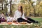 Young red haired woman waiting for her friends to join to the picnic