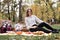 Young red haired woman waiting for her friends to join to the picnic