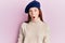 Young red head girl wearing french look with beret scared and amazed with open mouth for surprise, disbelief face