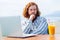 young redhaired ginger bearded man working outdoors in sea cafe with laptop an summer day