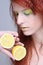 Young redhaired girl with lemon. close up