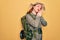 Young redhead backpacker woman hiking wearing backpack and hat over yellow background sleeping tired dreaming and posing with