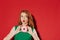 Young redhead cute girl in green dress with donut